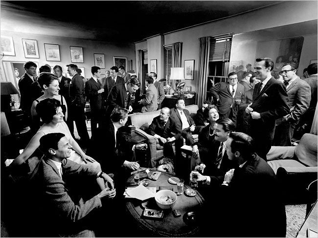 A cocktail party at George Plimpton’s apartment in 1963; Plimpton is seated at left. [Photo by Cornell Capa/Magnum Photos/NYT] 