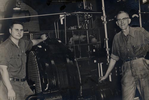 Bob Willis (left) with his helper Roy in the engine room of the Ice Plant , circa 1962.