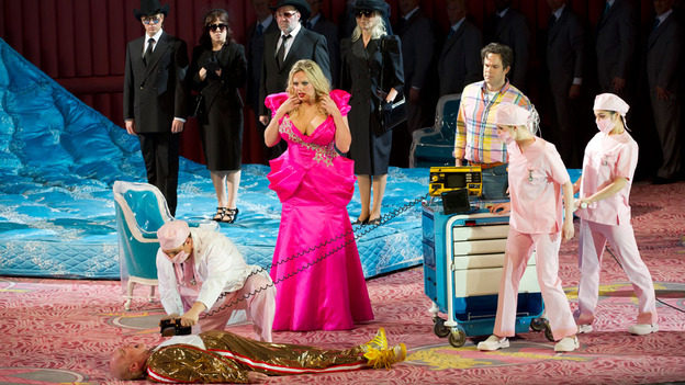 NO MADAME BUTTERFLY: Anna Nicole Smith, played by Dutch soprano Eva-Maria Westbroek, looks on in horror as J. Howard Marshall, played by Alan Oke, is seen dead on the floor in Covent Garden’s production of the opera “Anna Nicole.” [Photo by Bill Cooper/The Royal Opera/NPR]
